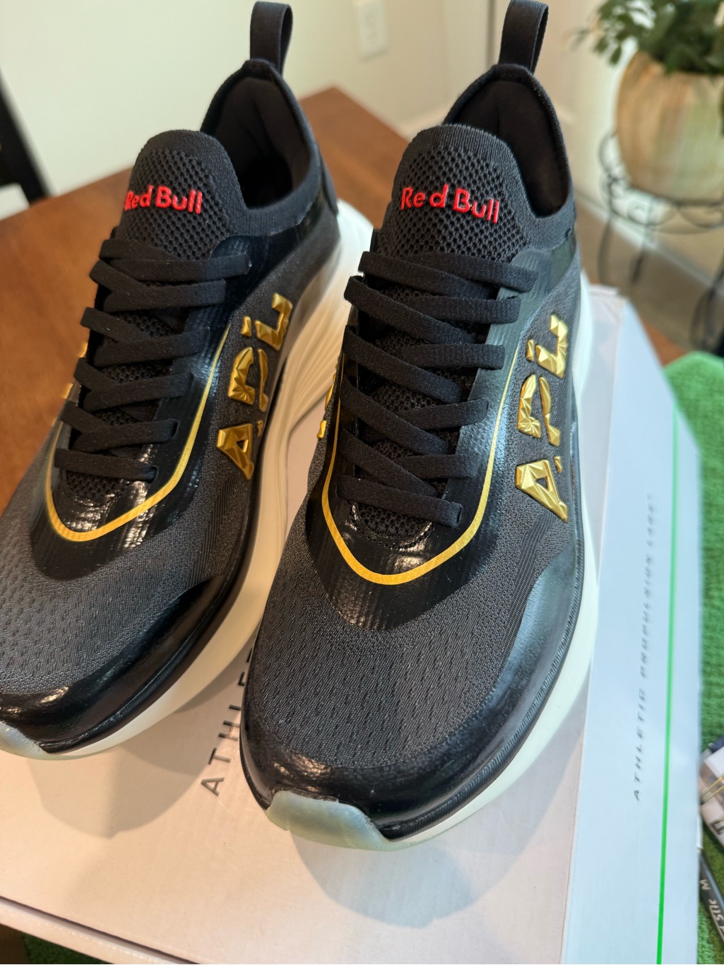 Apl Black Sneakers With Gold Accents And Red Branding